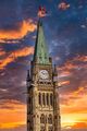 Canadian Parliament Buildings Peace Tower Set Against Vibrant Sunset Sky.jpg